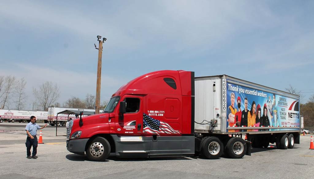 CDL student doing behind-the-wheel training on a tractor trailer at a New York truck driving school yard